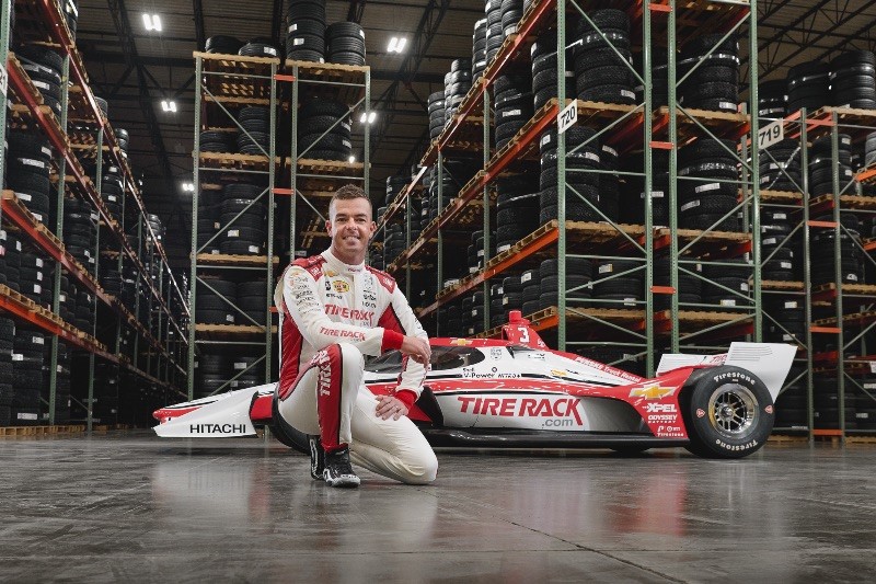 Team Penske's Scott McLaughlin and the No. 3 Team Penske Chevrolet at TireRack.com's South Bend, Ind. headquarters. The company is the primary sponsor for the upcoming Chevrolet Detroit Grand Prix, June 1, 2025.