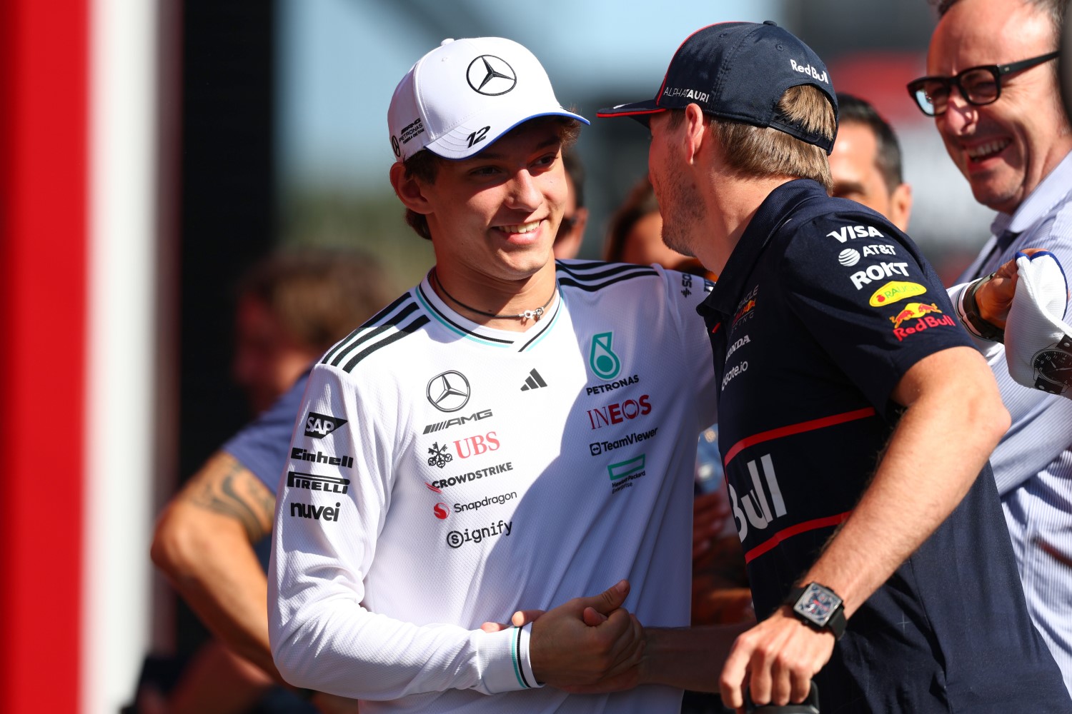 Andrea Kimi Antonelli of Italy and Mercedes AMG Petronas F1 Team and Max Verstappen of the Netherlands and Oracle Red Bull Racing greet each other in the Paddock during previews ahead of the F1 Grand Prix of Hungary at Hungaroring on July 31, 2025 in Budapest, Hungary. (Photo by Clive Rose/Getty Images) // Getty Images / Red Bull Content Pool //