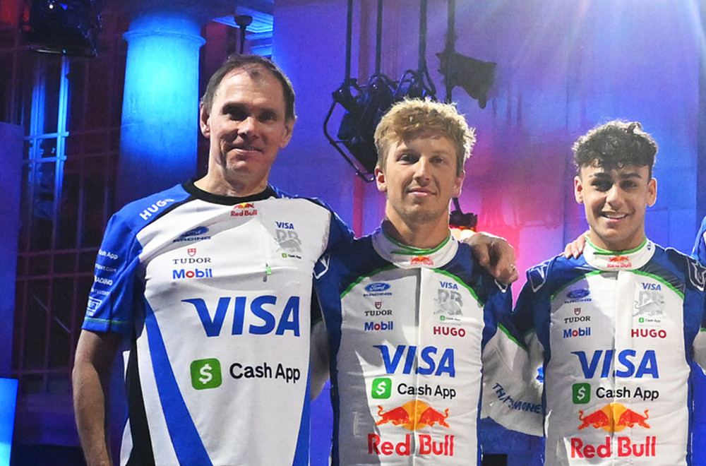 Alan Permane, Team Principal of Visa Cash App Racing Bulls, Liam Lawson of New Zealand and Visa Cash App Racing Bulls, Arvid Lindblad of Great Britain and Visa Cash App Racing Bulls and Peter Bayer, CEO of Visa Cash App Racing Bulls pose for a photo with their cars new livery on stage during the Visa Cash App Racing Bulls season launch at Michigan Central Station on January 15, 2026 in Detroit, Michigan. (Photo by Rudy Carezzevoli/Getty Images) // Getty Images / Red Bull Content Pool //