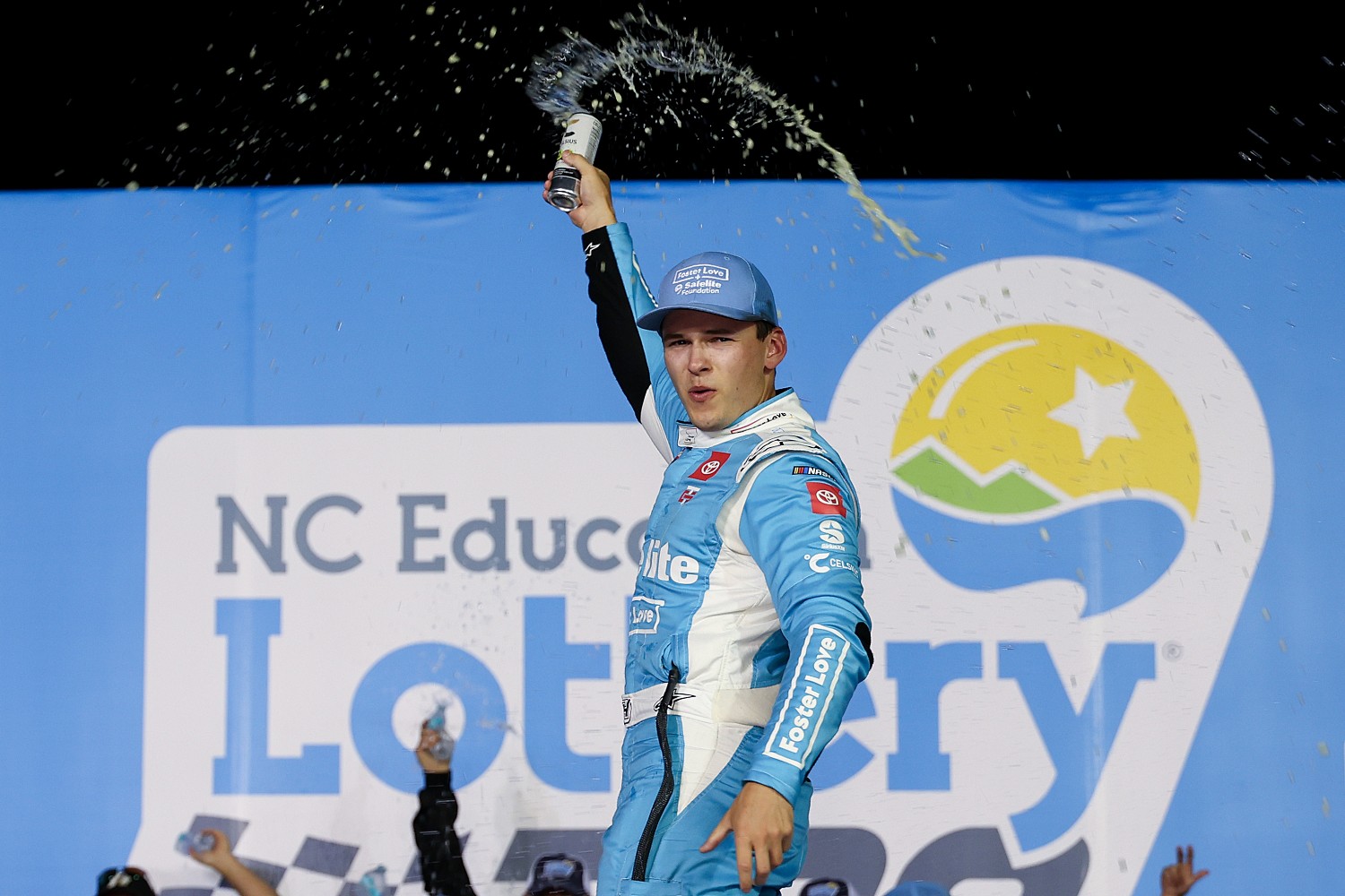 Corey Heim, driver of the #11 Safelite/Foster Love Toyota, celebrates in victory lane after winning the NASCAR Craftsman Truck Series North Carolina Education Lottery 200 at Charlotte Motor Speedway on May 23, 2025 in Concord, North Carolina. (Photo by David Jensen/Getty Images)