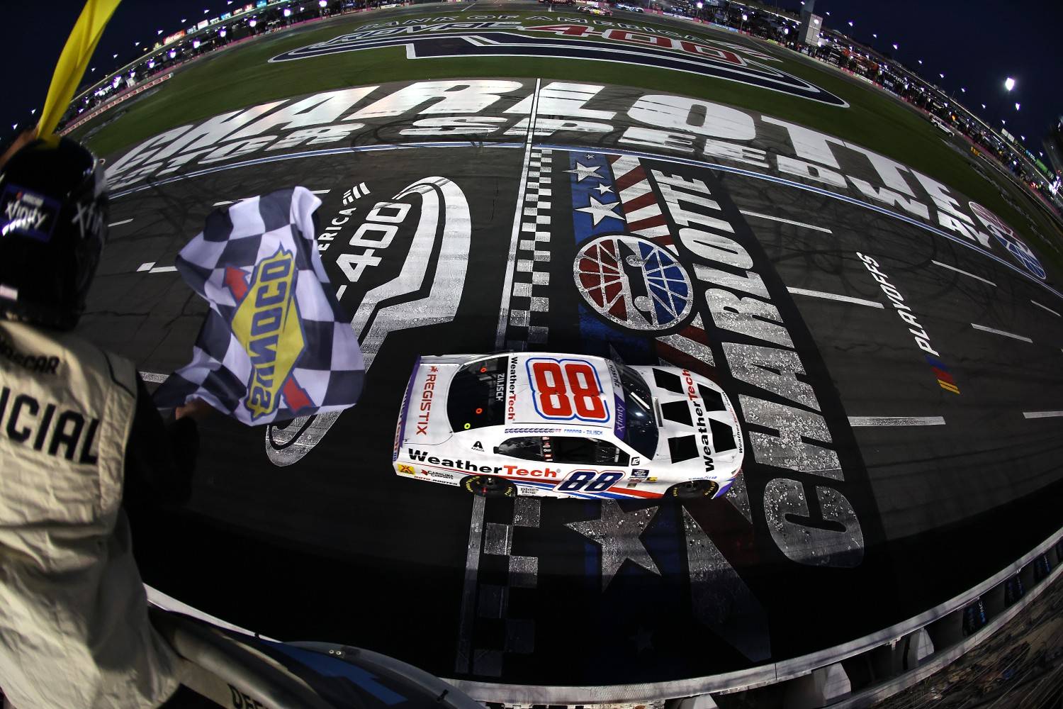 Connor Zilisch, driver of the #88 WeatherTech Chevrolet, takes the checkered flag under caution to win the NASCAR Xfinity Series Blue Cross NC 250 at Charlotte Motor Speedway on October 04, 2025 in Concord, North Carolina. (Photo by David Jensen/Getty Images for NASCAR)