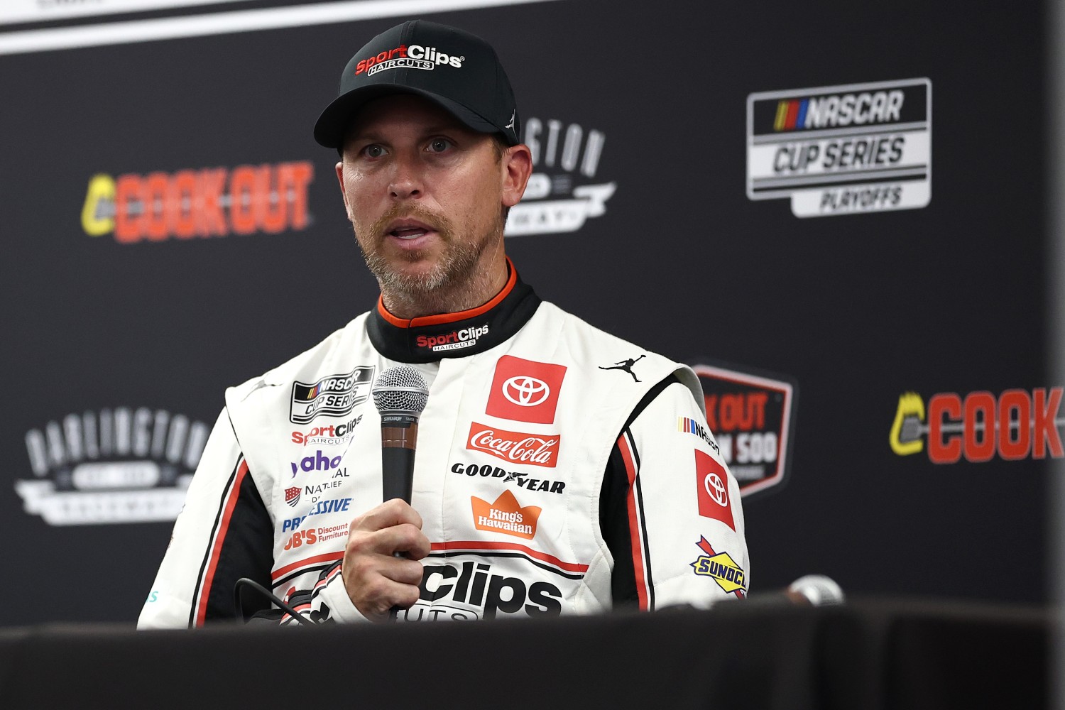 Denny Hamlin, driver of the #11 Sport Clips Haircuts Toyota, speaks to the media after winning the pole award during qualifying for the NASCAR Cup Series Cook Out Southern 500 at Darlington Raceway on August 30, 2025 in Darlington, South Carolina. (Photo by Jared C. Tilton/Getty Images)