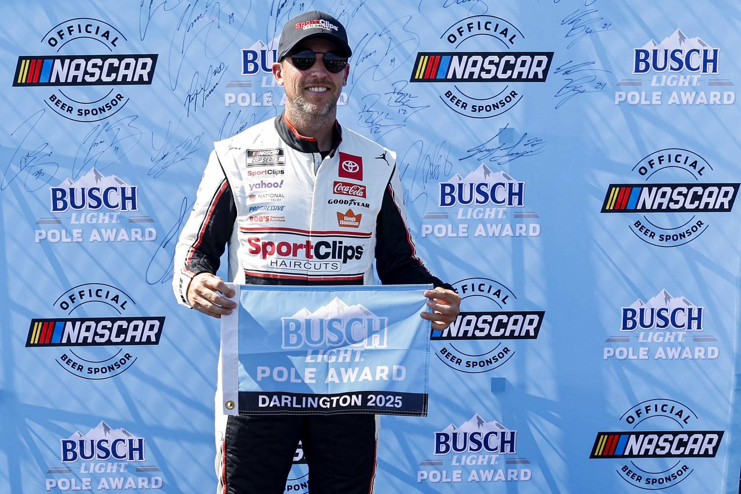 Denny Hamlin, driver of the #11 Sport Clips Haircuts Toyota, poses for photos after winning the pole award during practice for the NASCAR Cup Series Cook Out Southern 500 at Darlington Raceway on August 30, 2025 in Darlington, South Carolina. (Photo by Logan Riely/Getty Images)