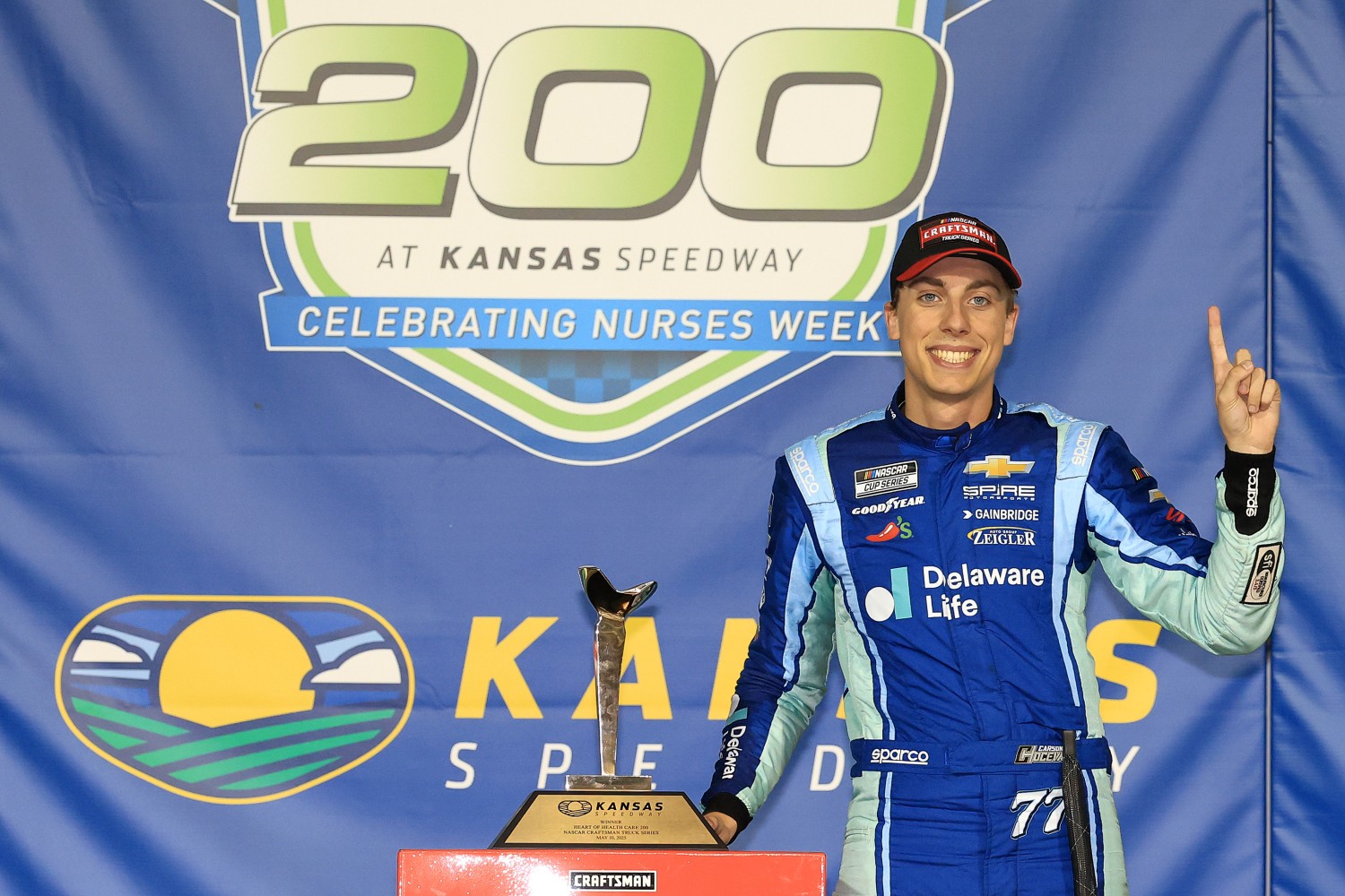 Carson Hocevar, driver of the #7 Delaware Life Chevrolet, celebrates in victory lane after winning the NASCAR Craftsman Truck Series Heart of Health Care 200 at Kansas Speedway on May 10, 2025 in Kansas City, Kansas. (Photo by Chris Graythen/Getty Images)
