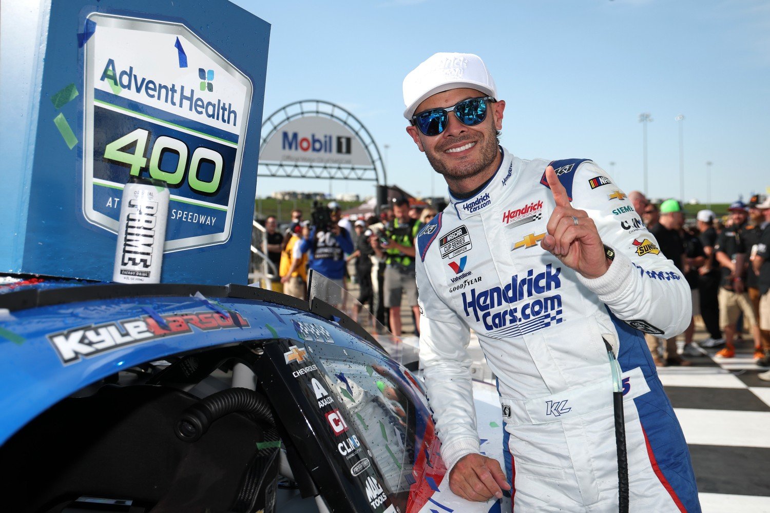 Kyle Larson, driver of the #5 HendrickCars.com Chevrolet, poses with the winner sticker on his car in victory lane after winning the NASCAR Cup Series AdventHealth 400 at Kansas Speedway on May 11, 2025 in Kansas City, Kansas. (Photo by Chris Graythen/Getty Images for NASCAR)