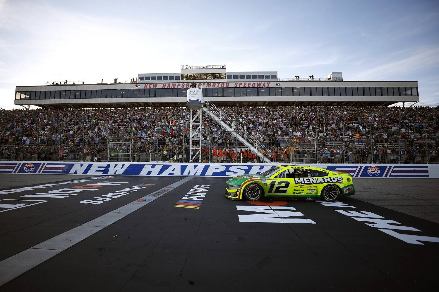 Ryan Blaney, driver of the #12 Menards/Libman Ford, drives as fans cheer after winning the NASCAR Cup Series Mobil 1 301 at New Hampshire Motor Speedway on September 21, 2025 in Loudon, New Hampshire. (Photo by Sean Gardner/Getty Images for NASCAR)