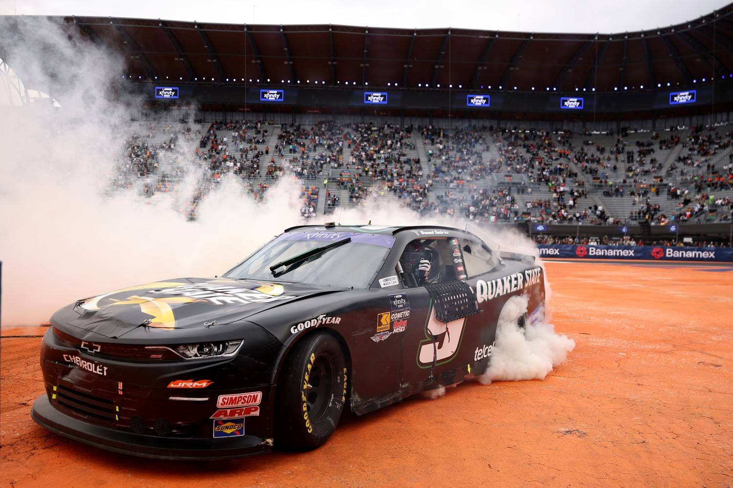 Daniel Suarez, driver of the #9 Quaker State Chevrolet, celebrates with a burnout after winning the NASCAR Xfinity Series The Chilango 150 at Autodromo Hermanos Rodriguez on June 14, 2025 in Mexico City, Mexico. (Photo by James Gilbert/Getty Images)
