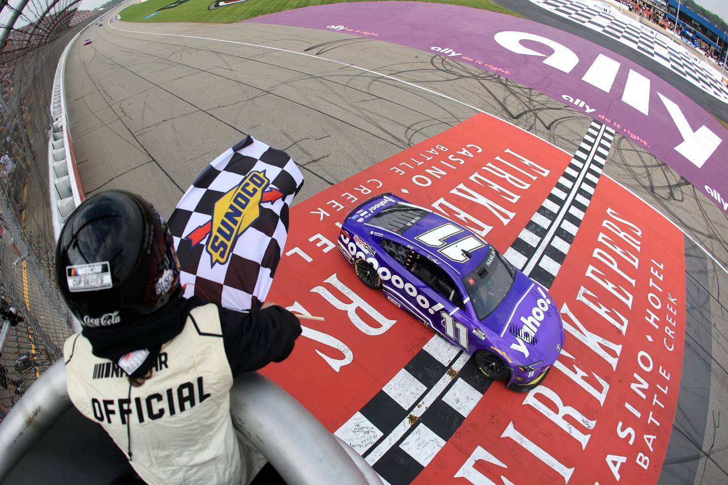 Denny Hamlin, driver of the #11 Yahoo! Toyota, takes the checkered flag to win the NASCAR Cup Series FireKeepers Casino 400 at Michigan International Speedway on June 08, 2025 in Brooklyn, Michigan. (Photo by Chris Graythen/Getty Images)