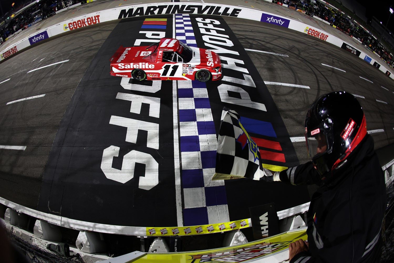 Corey Heim, driver of the #11 Safelite Toyota, takes the checkered flag to win the NASCAR Craftsman Truck Slim Jim 200 at Martinsville Speedway on October 24, 2025 in Martinsville, Virginia. (Photo by David Jensen/Getty Images for NASCAR)