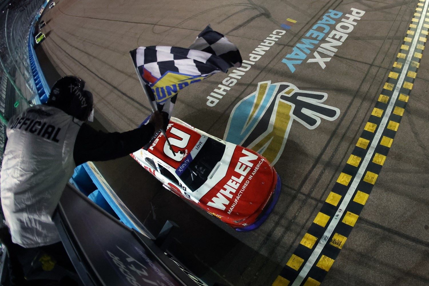 Jesse Love, driver of the #2 Whelen Chevrolet, takes the checkered flag to win the NASCAR Xfinity Series Championship at Phoenix Raceway on November 01, 2025 in Avondale, Arizona. (Photo by Meg Oliphant/Getty Images for NASCAR)