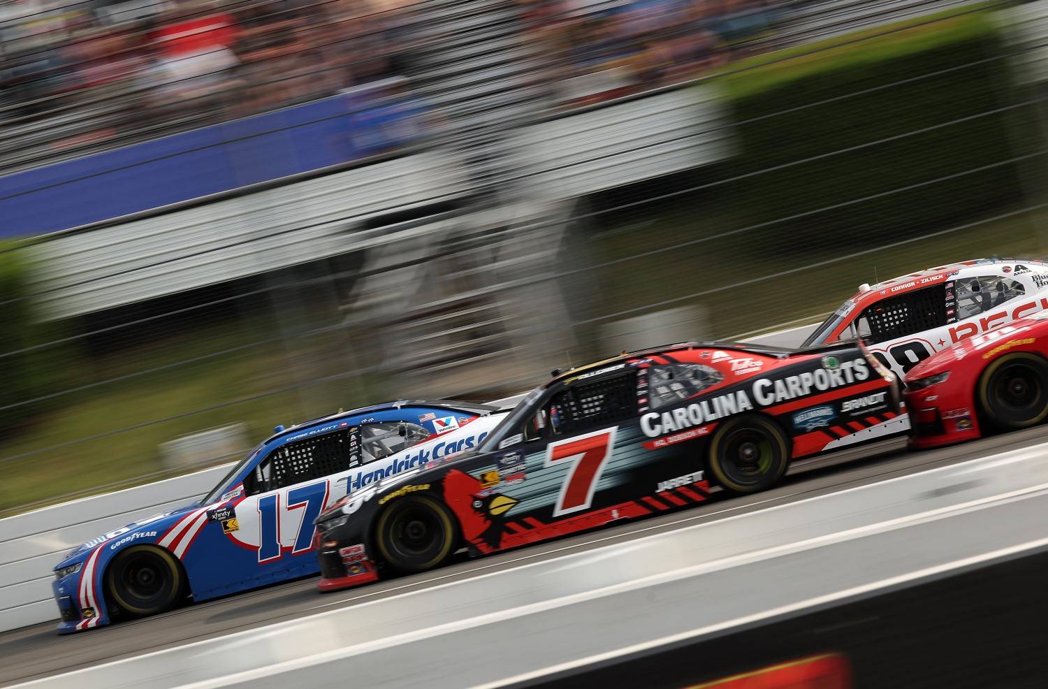 Chase Elliott, driver of the #17 HendrickCars.com Chevrolet, and Justin Allgaier, driver of the #7 Carolina Carports Chevrolet, race during the NASCAR Xfinity Series Explore the Pocono Mountains 250 at Pocono Raceway on June 21, 2025 in Long Pond, Pennsylvania. (Photo by Jonathan Bachman/Getty Images for NASCAR)