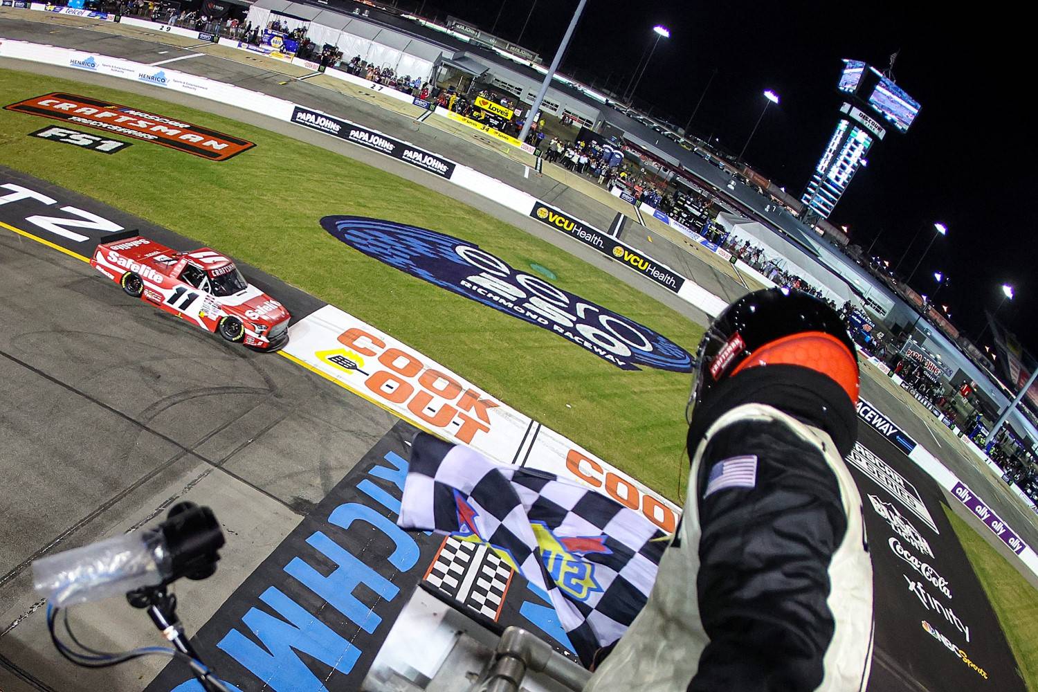 Corey Heim, driver of the #11 Safelite Toyota, takes the checkered flag to win the NASCAR Craftsman Truck Series eero 250 at Richmond Raceway on August 15, 2025 in Richmond, Virginia. (Photo by Chris Graythen/Getty Images)