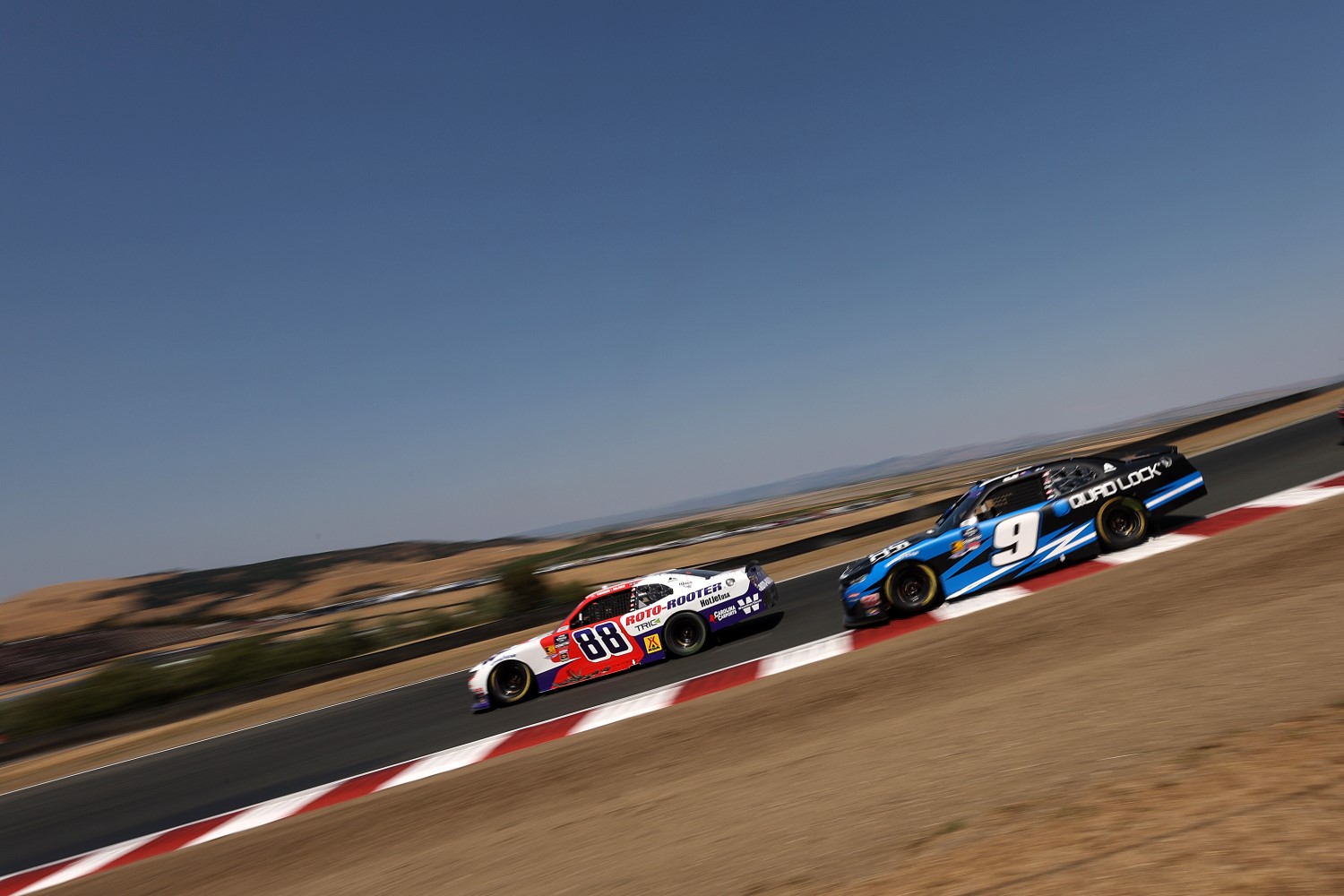 Connor Zilisch, driver of the #88 Roto-Rooter Chevrolet, leads Shane Van Gisbergen, driver of the #9 Quad Lock Chevrolet, during the NASCAR Xfinity Series Pit Boss/FoodMaxx 250 at Sonoma Raceway on July 12, 2025 in Sonoma, California. (Photo by Meg Oliphant/Getty Images)