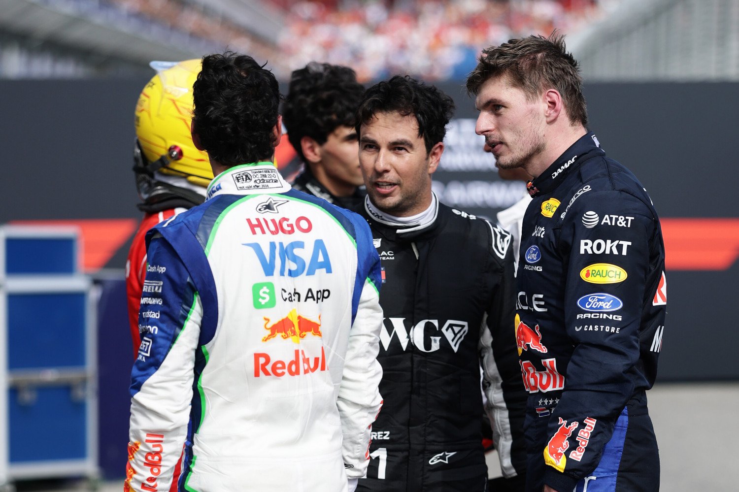 Eighth placed Arvid Lindblad of Great Britain and Visa Cash App Racing Bulls Sixteenth placed Sergio Perez of Mexico and Cadillac F1 Team and Sixth placed Max Verstappen of the Netherlands and Oracle Red Bull Racing talk in parc ferme during the F1 Grand Prix of Australia at Albert Park Grand Prix Circuit on March 08, 2026 in Melbourne, Australia. (Photo by Mark Thompson/Getty Images) // Getty Images / Red Bull Content Pool //