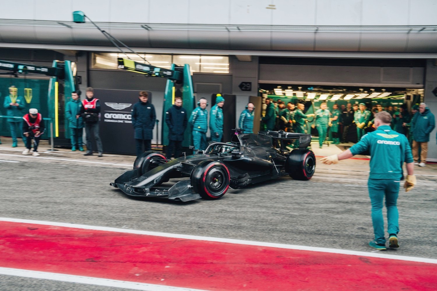 Lance Stroll pulls the radical Adrian Newey AMR26 out of the garage on Day 4 of the 2026 Formula 1 preseason test in Barcelona. Note the unconventional radiator inlet openings. Image supplied by the Aston Martin F1 team