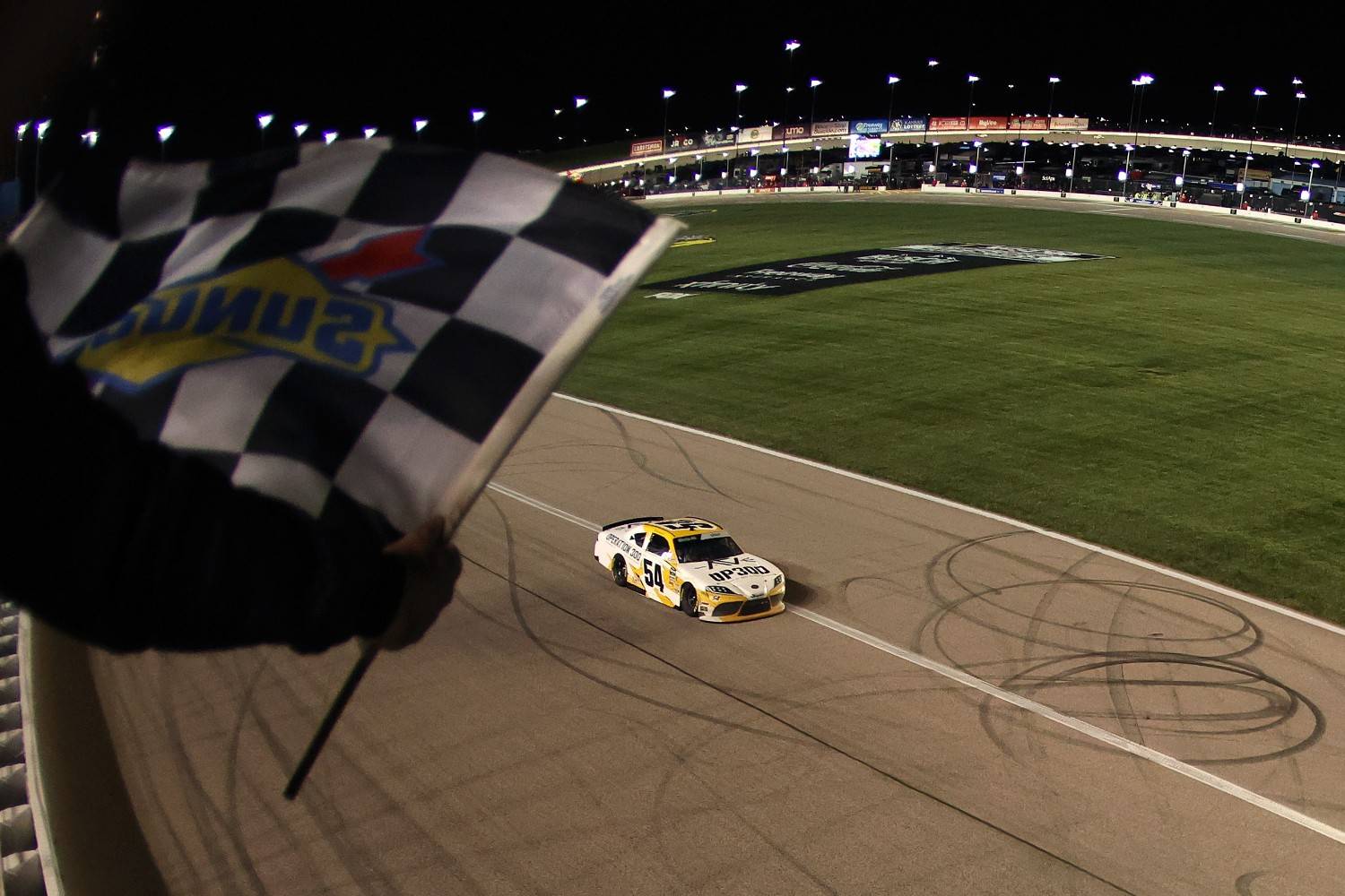 Taylor Gray, driver of the #54 Operation 300 Toyota, takes the checkered flag to win the NASCAR O'Reilly Auto Parts Series Kansas Lottery 300 at Kansas Speedway on April 18, 2026 in Kansas City, Kansas. (Photo by David Jensen/Getty Images)