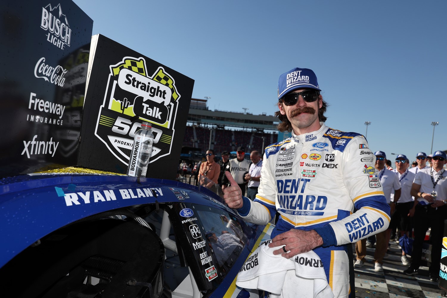 Ryan Blaney, driver of the #12 Dent Wizard Ford, poses with the winner sticker on his car in victory lane after winning the NASCAR Cup Series Straight Talk Wireless 500 at Phoenix Raceway on March 08, 2026 in Avondale, Arizona. (Photo by Meg Oliphant/Getty Images)