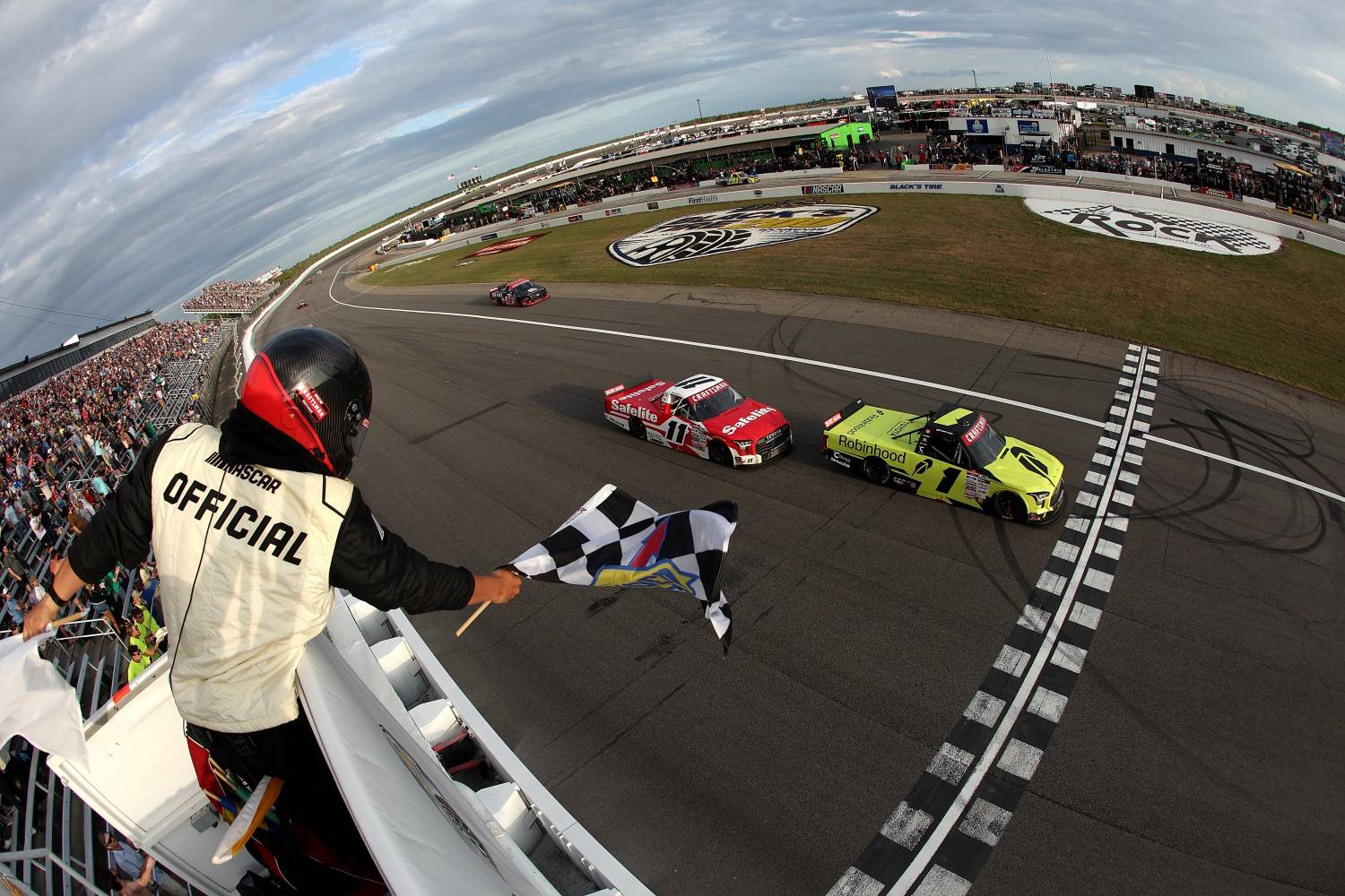 Corey Heim, driver of the #1 Robinhood Toyota, takes the checkered flag ahead of Kaden Honeycutt, driver of the #11 Safelite Toyota, to win the NASCAR Craftsman Truck Series Black's Tire 200 at Rockingham Speedway on April 03, 2026 in Rockingham, North Carolina. (Photo by Meg Oliphant/Getty Images for NASCAR)