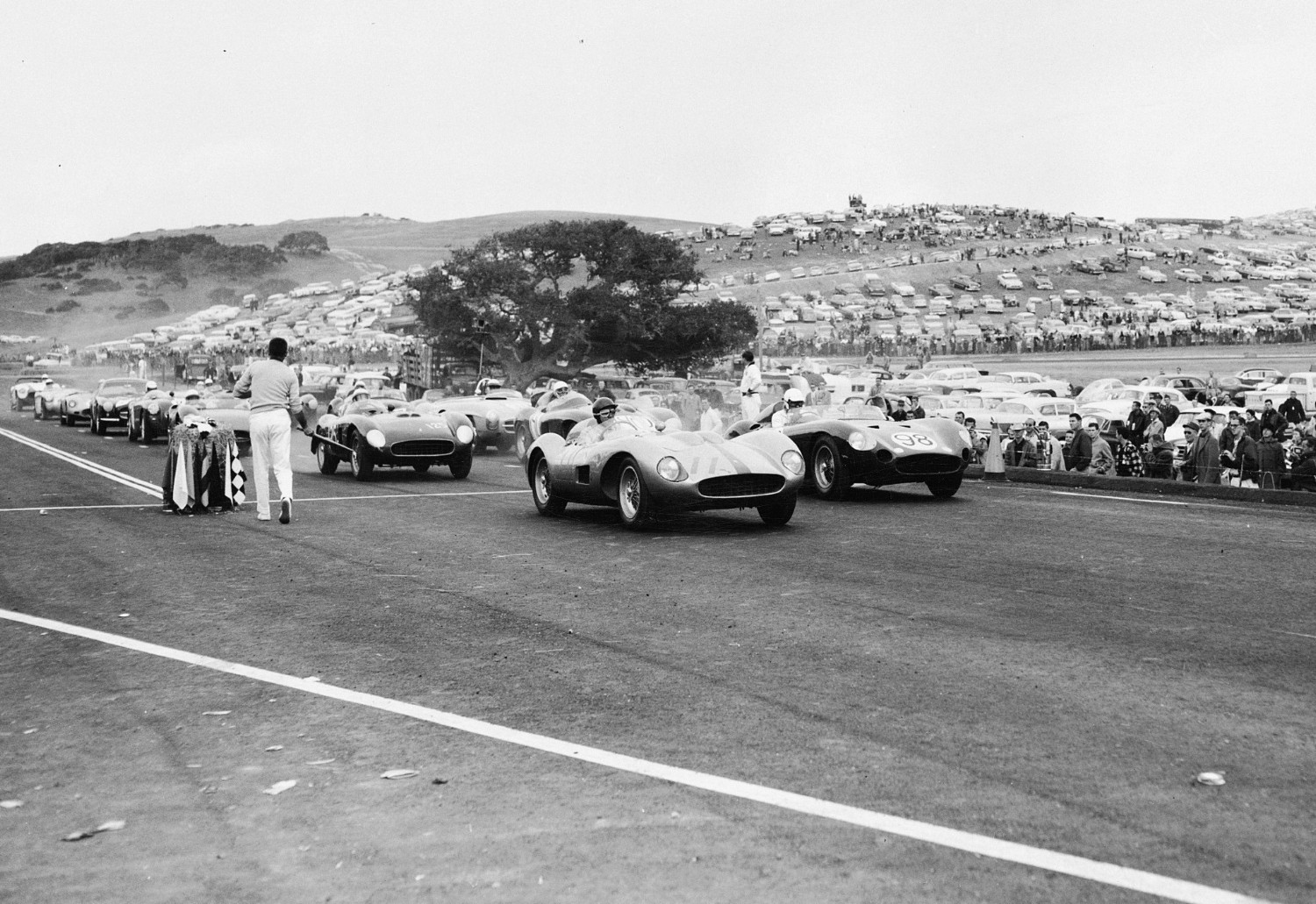 John Von Neumann in the (11) Ferrari TR takes pole against Carroll Shelby (98) in a Maserati 450S, while eventual race winner Pete Lovely (125) in a 2-litre Ferrari TR sits in third for the start of the inaugural race November 1957. Note how close spectators are to the race track.