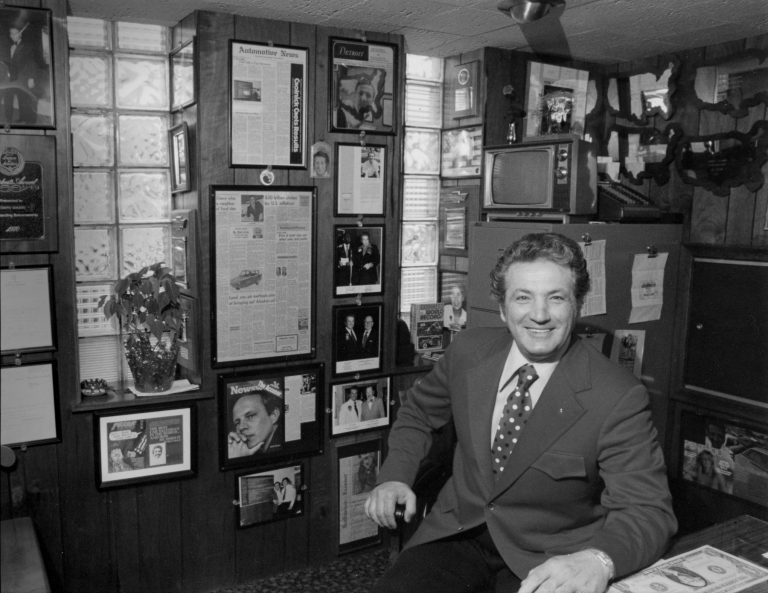 In his office. He averaged 6 new car sales per day, every day, for 13 years.