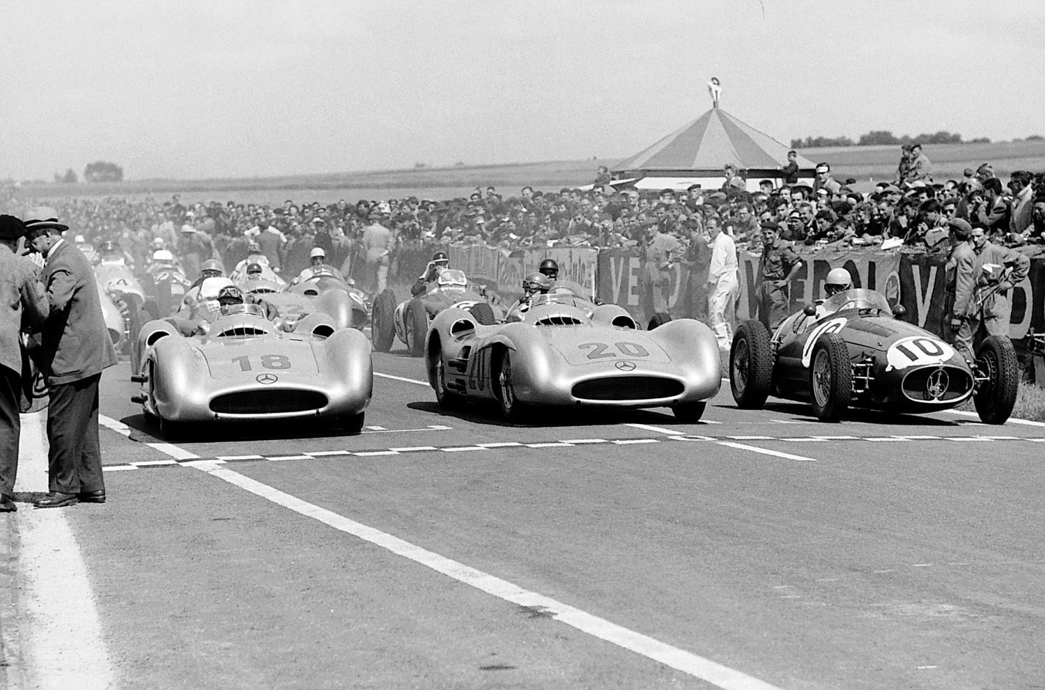 Double victory in the French Grand Prix in Reims, July 4, 1954. Lining up in the first row before the start: Juan Manuel Fangio (start number 18), the winner of the race, Karl Kling (start number 20) who finished in second place, both driving Mercedes-Benz W 196 R Formula One racing cars, and Alberto Ascari (start number 10) at the wheel of a Maserati 250 F.