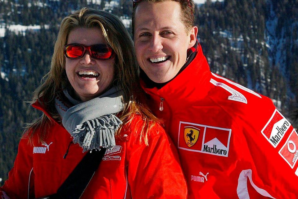 German Formula 1 driver Michael Schumacher poses with his wife Corinna, in the winter resort of Madonna di Campiglio, in the Dolomites area, Northern Italy, 11 January 2005. Schumacher takes part in the traditional Ferrari winter meeting with the press. (Photo by FERRARI PRESS OFFICE / AFP via Getty Images)